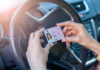 Massive ID Shake-Up: Kansas Residents in Limbo Person holding drivers license inside a car