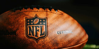 Close-up of an NFL football on grass.