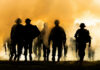 Military Crisis: Europe’s Desperate Recruitment Gamble Silhouettes of soldiers walking through smoke at sunset