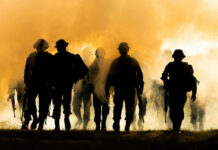 Military Crisis: Europe’s Desperate Recruitment Gamble Silhouettes of soldiers walking through smoke at sunset