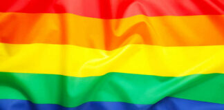 Rainbow pride flag with six horizontal stripes.