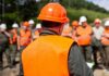 Group of workers in safety gear attending a briefing