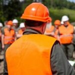 Group of workers in safety gear attending a briefing