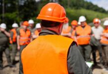 Group of workers in safety gear attending a briefing