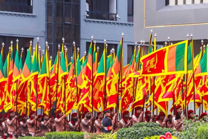 Group of individuals in traditional attire holding flags during a parade