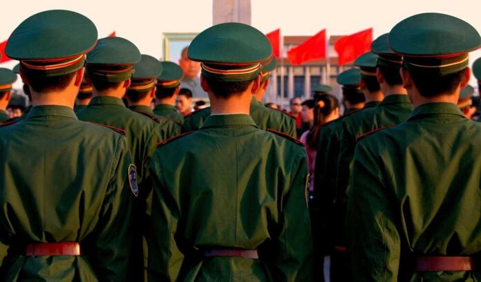 Group of uniformed soldiers standing in formation during a ceremony
