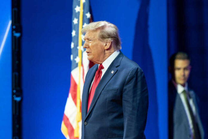 Man in suit with American flag background