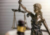 DA’s Bold Move Bypasses NY Sanctuary Laws Blindfolded lady justice statue with scales and gavel