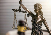 Blindfolded lady justice statue with scales and gavel