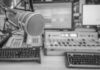 Microphone in radio studio with mixing equipment