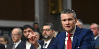 Man speaking at a panel discussion meeting