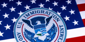 Seal of U.S. Immigration and Customs Enforcement on an American flag background