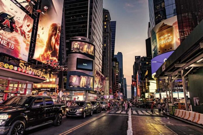 Busy street scene in Times Square with cars and pedestrians