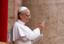 Pope clapping and smiling during a public appearance