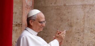 Pope clapping and smiling during a public appearance