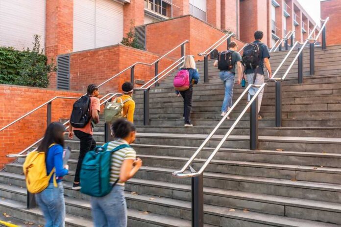Group of students ascending outdoor stairs on a campus
