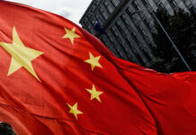 Chinese Satellites EXPOSE U.S. Troop Moves Close-up of the Chinese flag waving in the wind