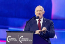 Person speaking at Turning Point USA event podium