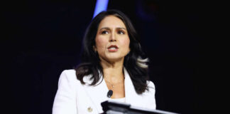 Person speaking at a podium with microphone.