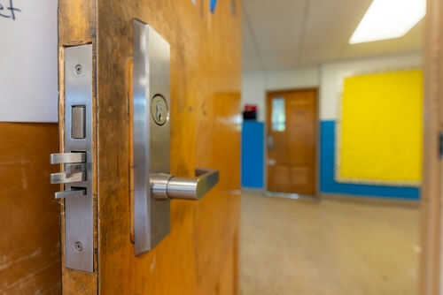 2355772873 Door opening into an empty classroom.