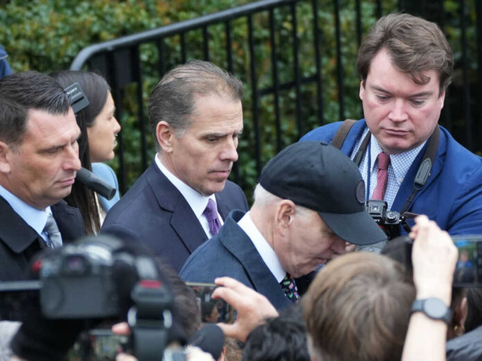 biden-and-his-son-hunter2444717505jpg-1 Group of men in suits walking through a crowd