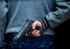 Gun Printing Teen Raises Alarming Questions! Person holding a handgun behind their back