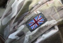 Close-up of a military uniform with a British flag patch