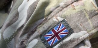 Close-up of a military uniform with a British flag patch