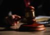 Subpoena Shock: SPLC Records Demanded A wooden gavel resting on a table with a blurred hand in the background