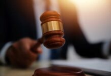 Denaturalization Push: Spy Ambassador on the Line A gavel being struck on a desk in a courtroom setting