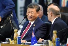 Two political leaders engaged in conversation at a conference