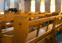 Church Bathroom Standoff Sparks Instant Arrest Bathroom sign in a hallway.