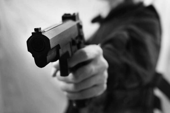 Black,And,White,Man,Shot,Gun Close-up of a person holding a handgun in a threatening manner