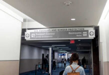 Woman walking towards US customs and passport control