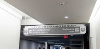 Woman walking towards US customs and passport control