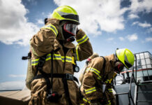 Days-Long Blaze Rattles Boyle Heights Firefighters in protective gear standing outside cloudy sky