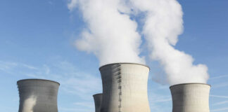 Cooling towers at a power plant releasing steam