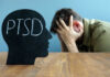 Silhouette with PTSD text, distressed man in background.