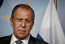 Man in suit with Russian flag backdrop