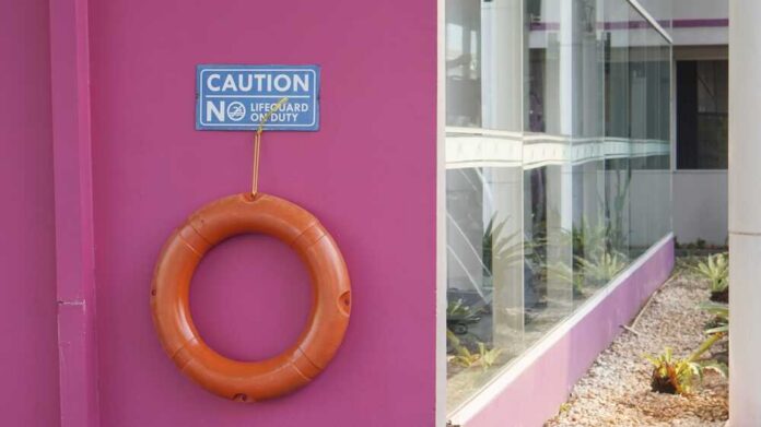 Ring,Buoy,At,Swimming,Pool. Medic walking near an ambulance in a park