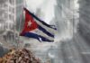 Bejucal Antennas Activate—Targets Closer Than You Think Worn Cuban flag standing on rubble in a desolate urban environment