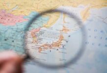 Japan Bets Big on ‘Cheap’ Rocket A magnifying glass focusing on a map of Japan