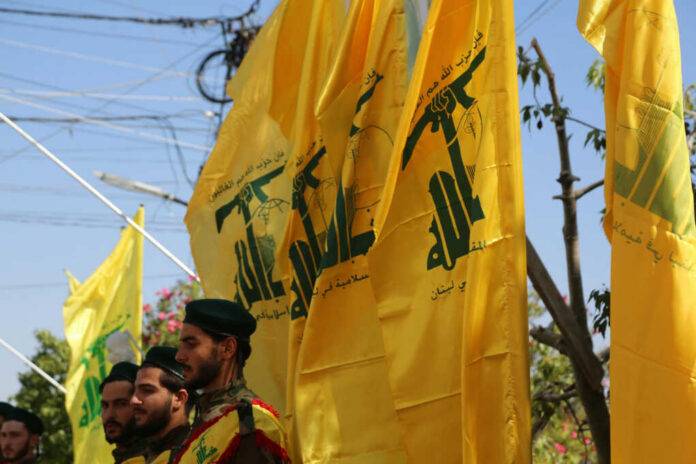 yellow-hezbollah-flags2379767211jpg Men standing with yellow flags wearing green berets