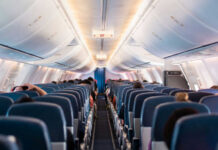 Interior view of airplane cabin with passengers
