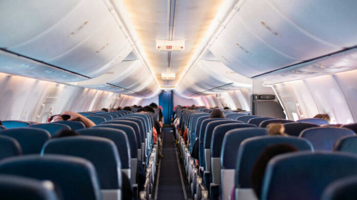 Interior view of airplane cabin with passengers