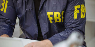 FBI agent working on laptop indoors