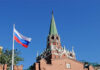 War Footing Surges — Russia Warned Russian flag and Kremlin tower against a clear blue sky