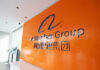 Alibaba Group logo on an orange wall in a modern office lobby
