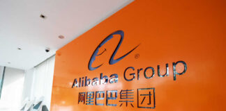 Alibaba Group logo on an orange wall in a modern office lobby