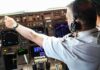 Pilot adjusting controls in an airplane cockpit